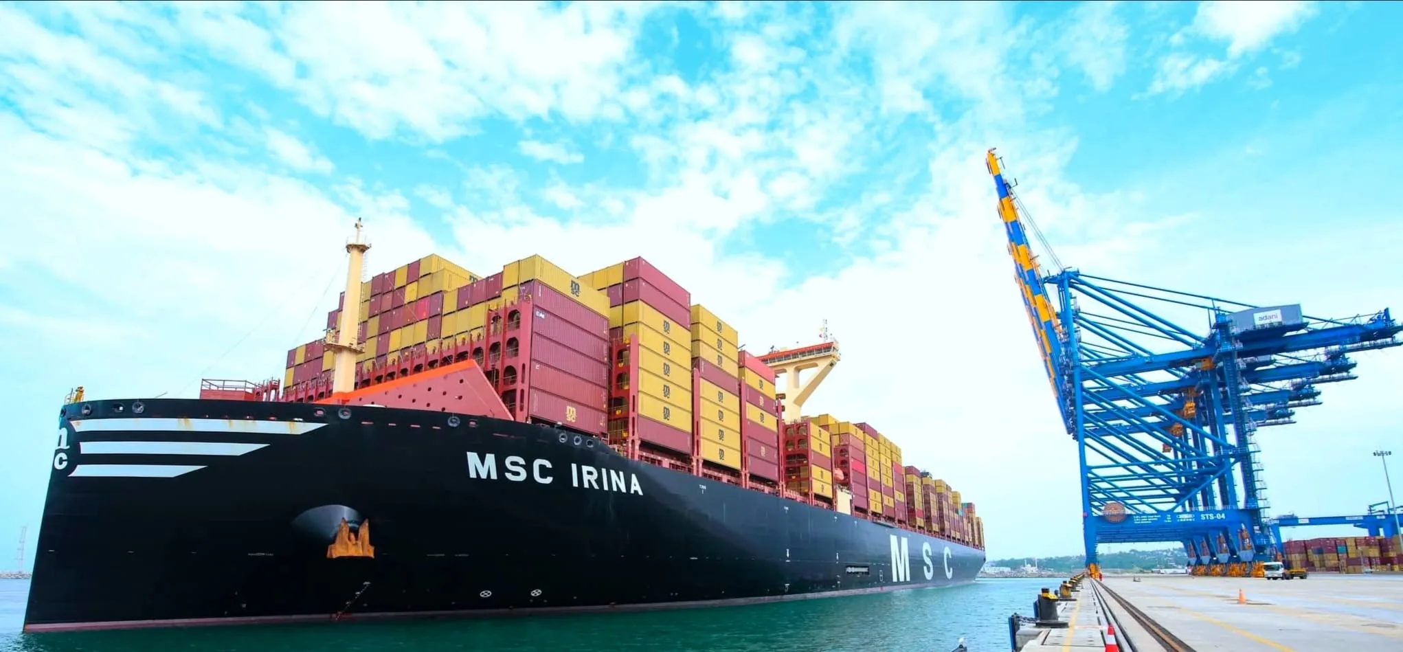 A large container ship berthed beside ship-to-shore cranes at Vizhinjam port, Kerala