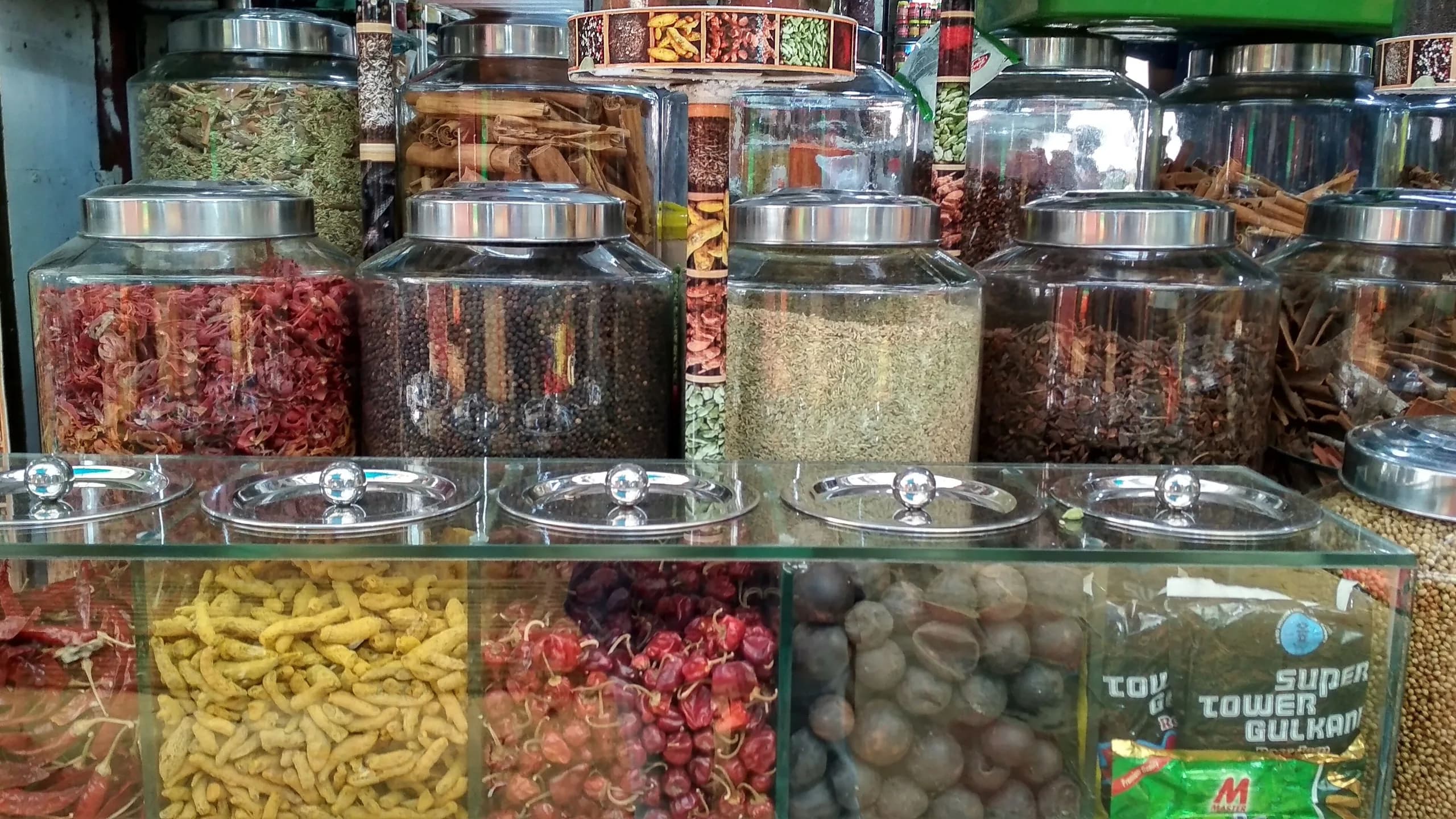 Glass jars of whole spices on display at a market in Thiruvananthapuram, Kerala